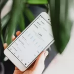 Person holding phone with Instagram analytics.