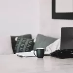 Workspace with cup and computer for person to make $35,000 a year.