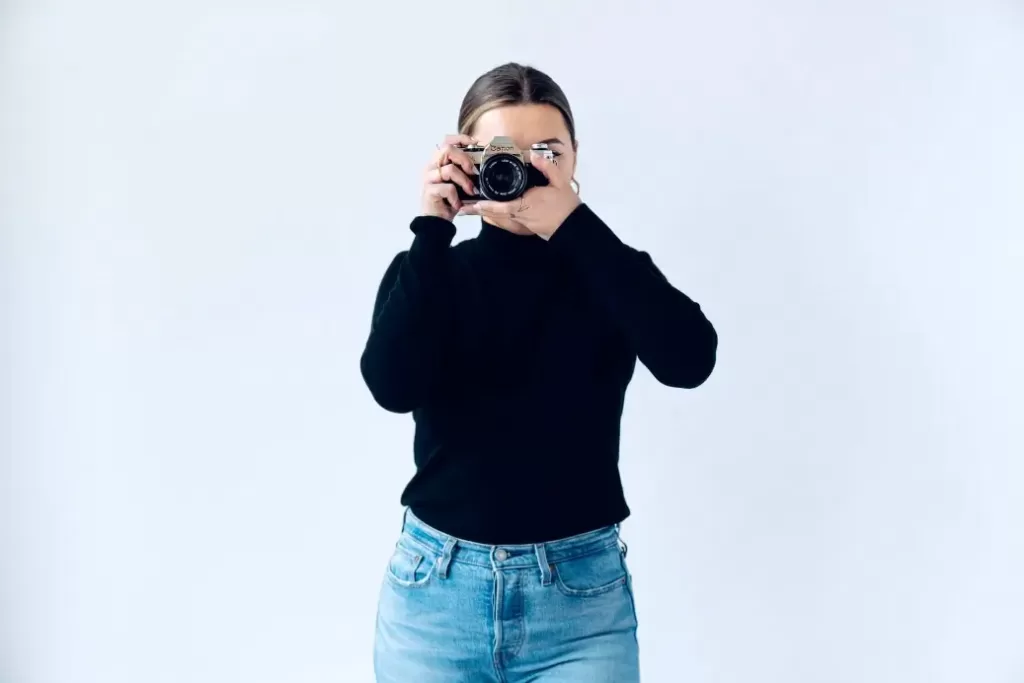 Woman with a camera making $36,000 a year.