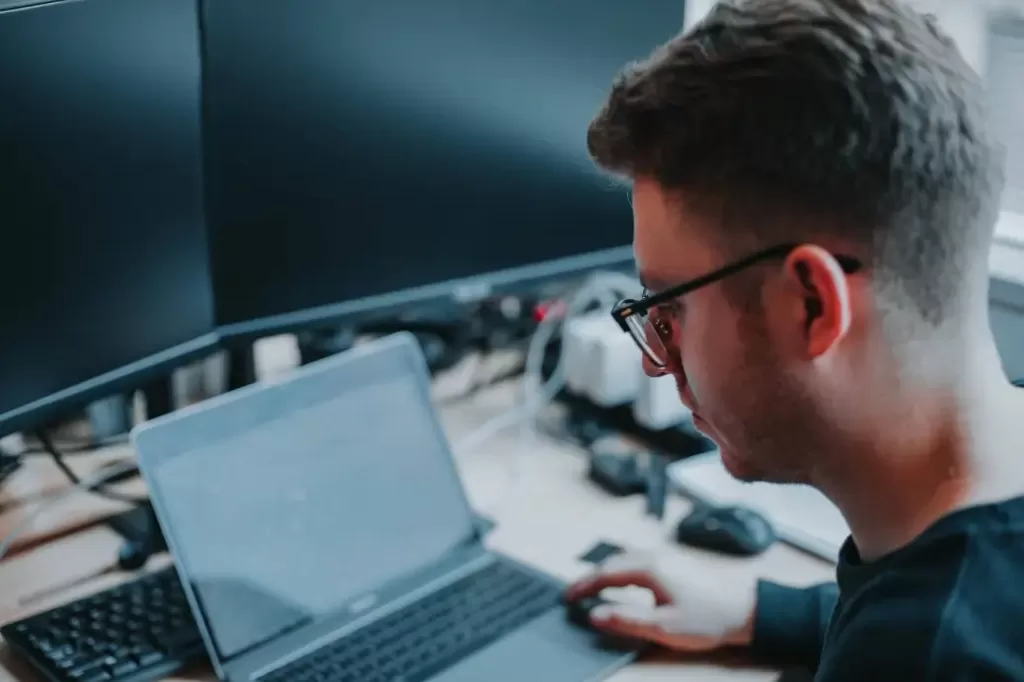 Man working on computer to earn $39,000 a year.