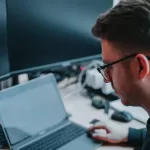 Man working on computer to earn $39,000 a year.