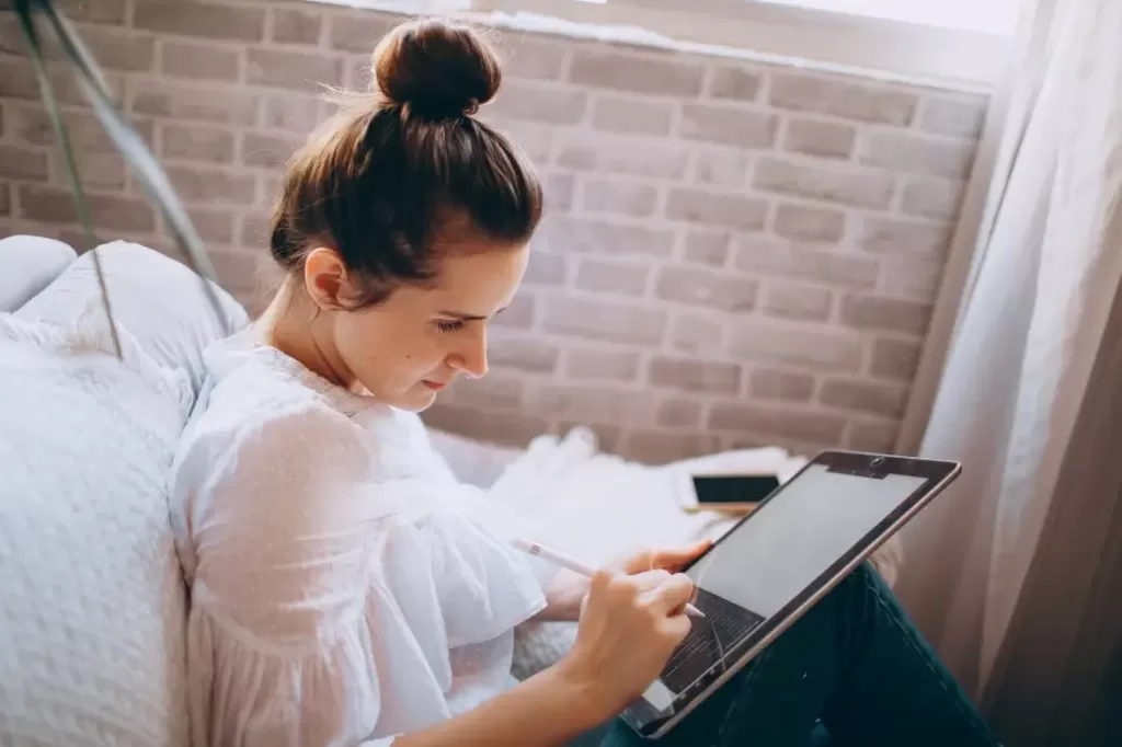 Woman working on a tablet earning $40,000 a year.