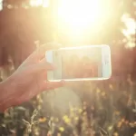Person that earns $41,000 a year holding a phone to take a picture.