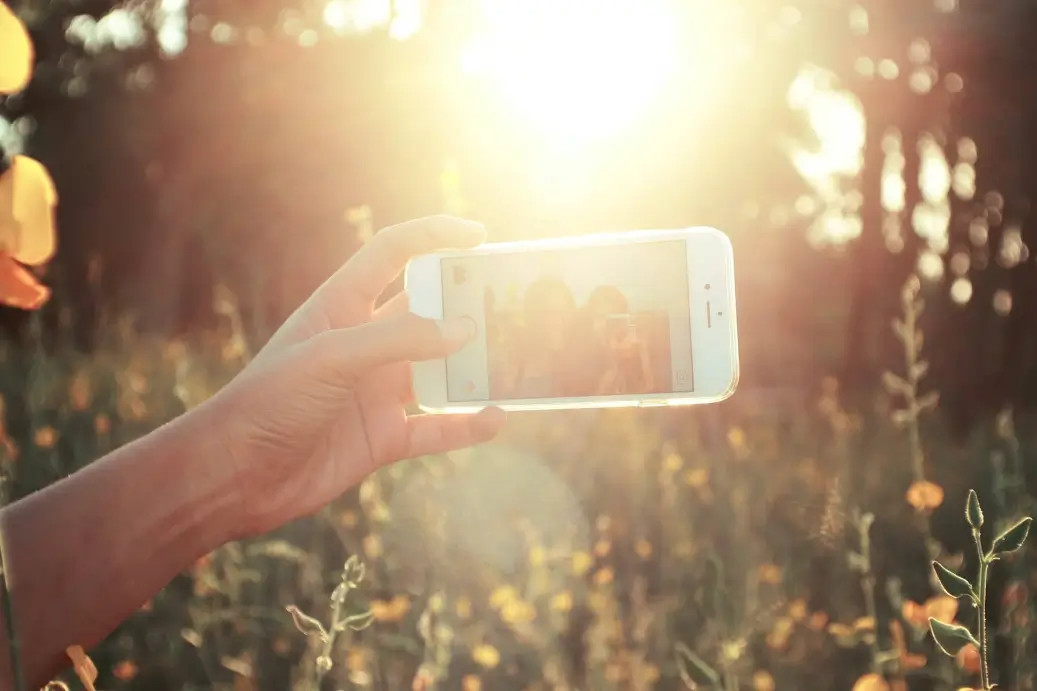 Person that earns $41,000 a year holding a phone to take a picture.