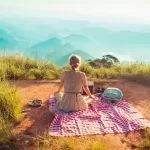 Woman that makes $43,000 a year sitting in an area surrounded by grass.