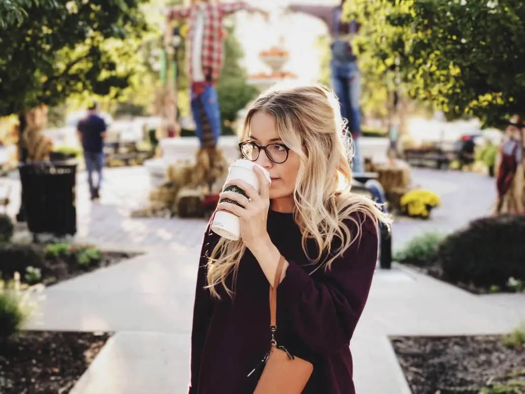 Woman with a coffee cup earning $54,000 a year.