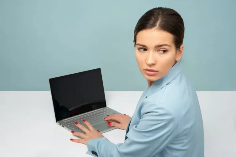 Woman working on a laptop making $64,000 a year.