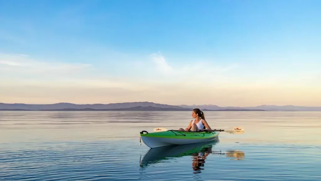 Woman sitting in a kayak making $88,000 a year.